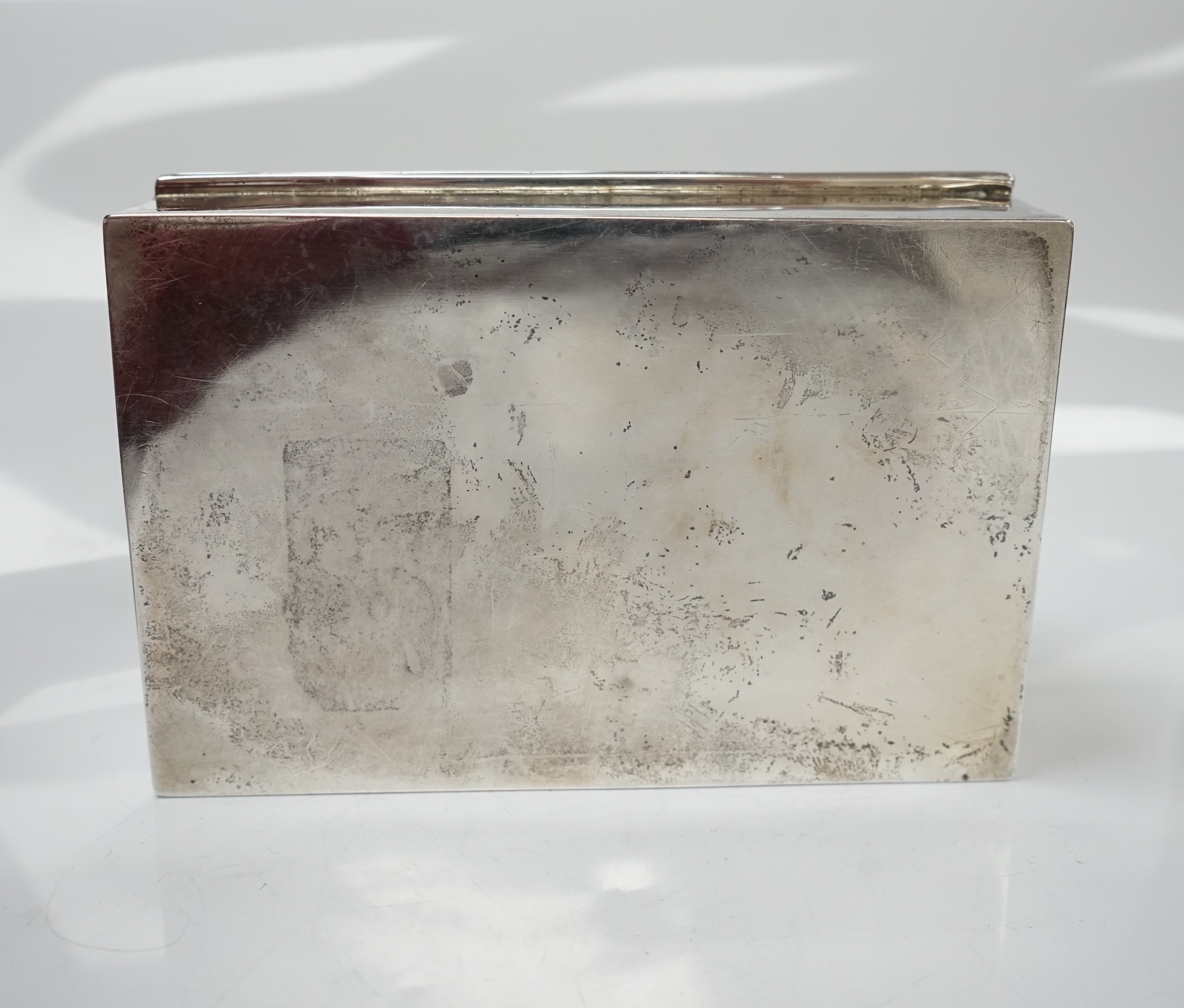 Two silver cigarette boxes, the largest by Stokes & Ireland, Chester, 1906, 14.7cm. Condition - poor to fair